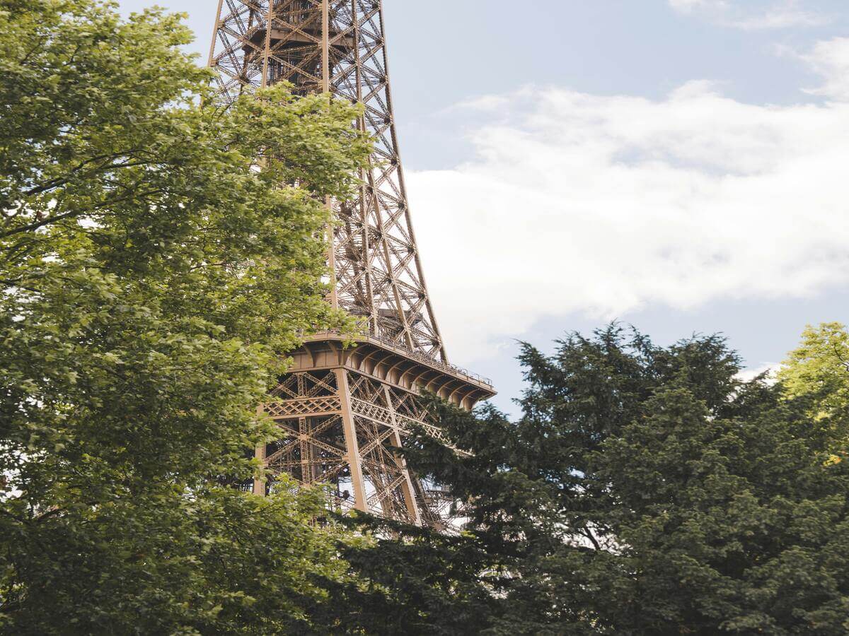 Eiffel Toer in Paris viewed through trees near Champ de Mars