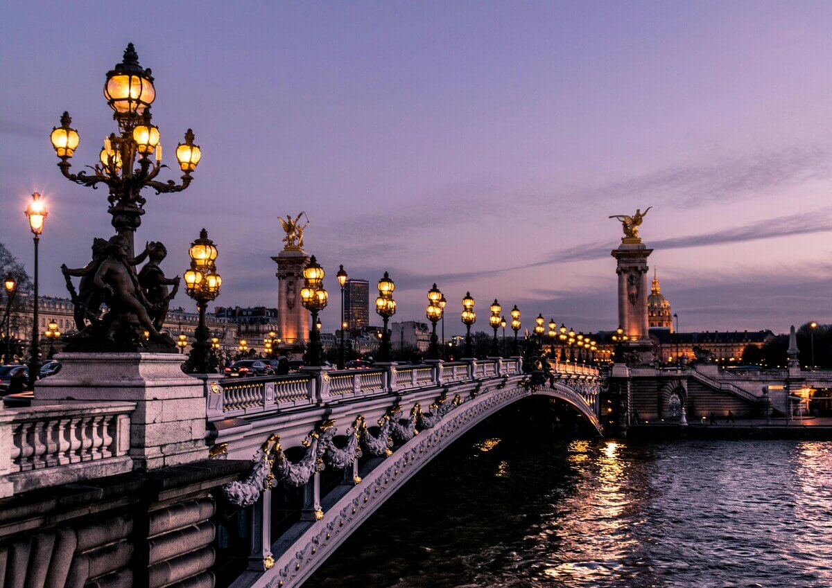 pont Alexandre III at sunset in Paris with illuminated lamps and seine river view