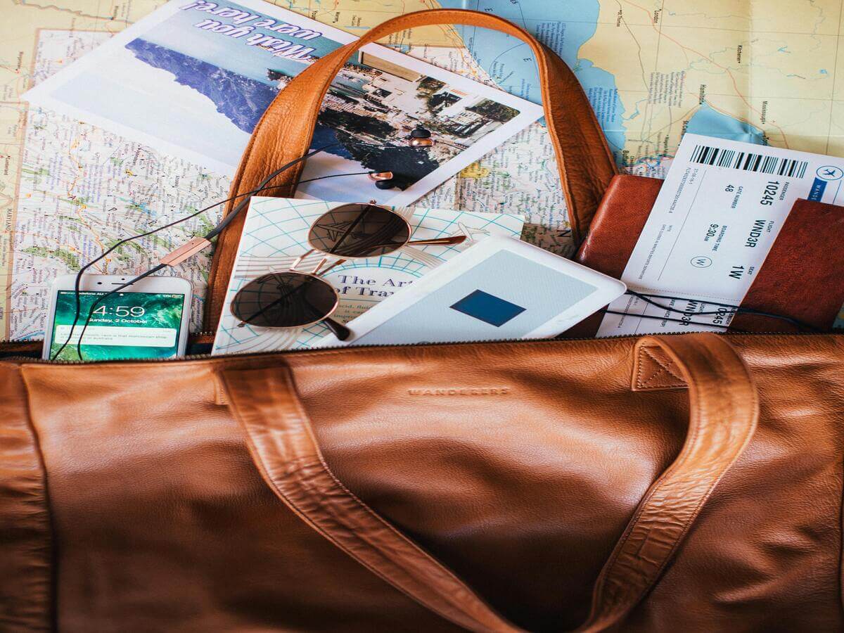Packing essentials for a Europe trip including passport, tickets, sunglasses and travel items
