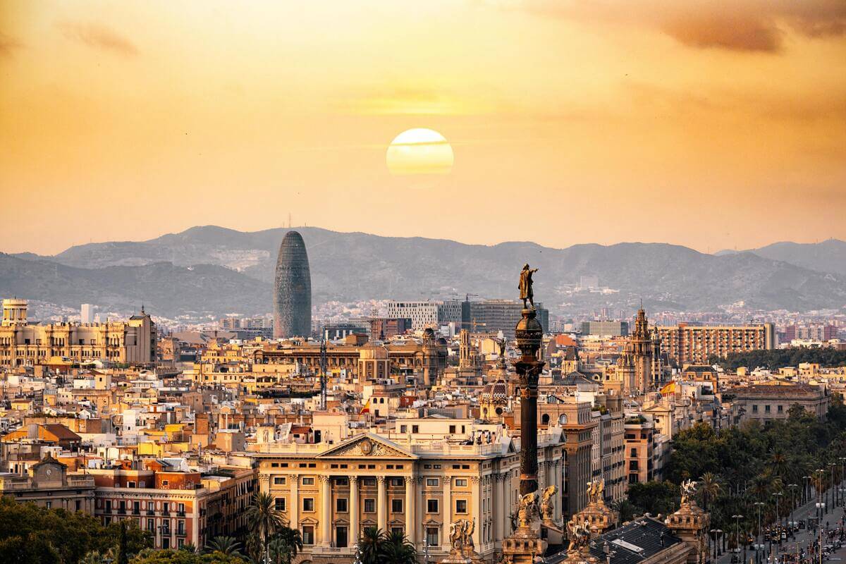 Barcelona skyline at sunset with Sagrada Familia and Torre Glòries in the background