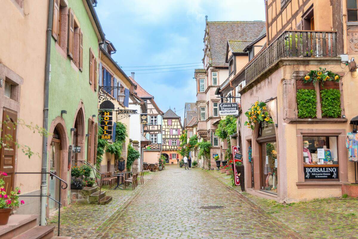 Charming European village street with colourful houses, cobblestone road and traditional architecture