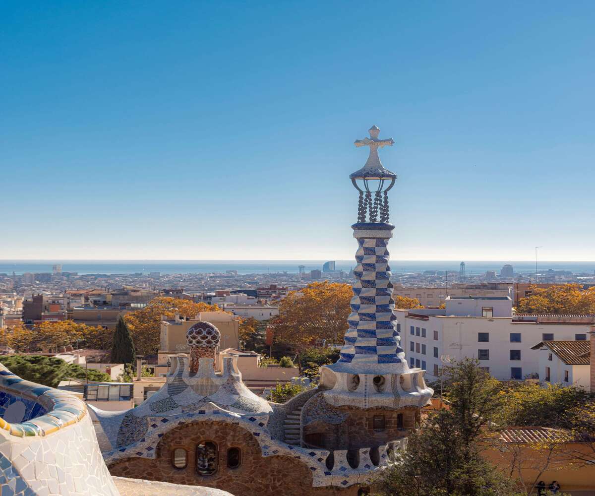 View over Barcelona from Park Güell with Gaudí mosaic architecture and city skyline